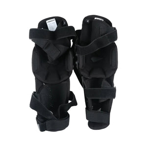 AXOR Impact-X black knee guards with dual-axis bionic design, hard shell sliders, and adjustable straps.