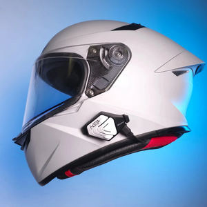 Motodrift BluArmor HS3 Bluetooth headset mounted on the side of a white full-face motorcycle helmet