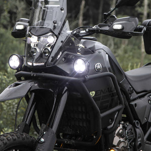 DENALI D3 LED driving lights mounted on a black adventure motorcycle, showing bright spot beam illumination.