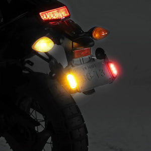 DENALI T3 modular LED rear signal pods with red brake and amber turn signal lights mounted on a motorcycle.