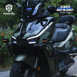 Future Eyes X60 LED auxiliary lights mounted on a matte green adventure scooter for enhanced night visibility