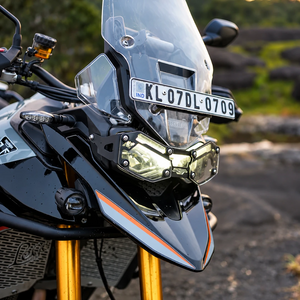 black steel Oculus headlight shield installed on a Triumph Tiger 900 motorcycle for adventure protection