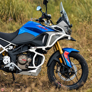 White Raptor crash guard set installed on a blue TVS Apache RTX 300 motorcycle in a grassy field