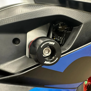 MK Racing black Delrin frame slider installed on an Aprilia RS 457 motorcycle with red accent ring