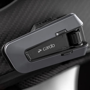 Motodrift Cardo Packtalk Edge motorcycle communication system mounted on a helmet with a sleek black design.