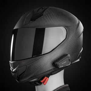 Motodrift Cardo Spirit HD Bluetooth intercom mounted on a carbon fiber motorcycle helmet against a black background