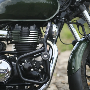 Motodrift Moto Torque V2.0 black steel crash guard installed on a green Honda motorcycle engine