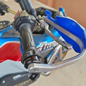 Motodrift Pro-Spec Easy Cruz mechanical throttle lock installed on a motorcycle handlebar with Barkbusters hand guards
