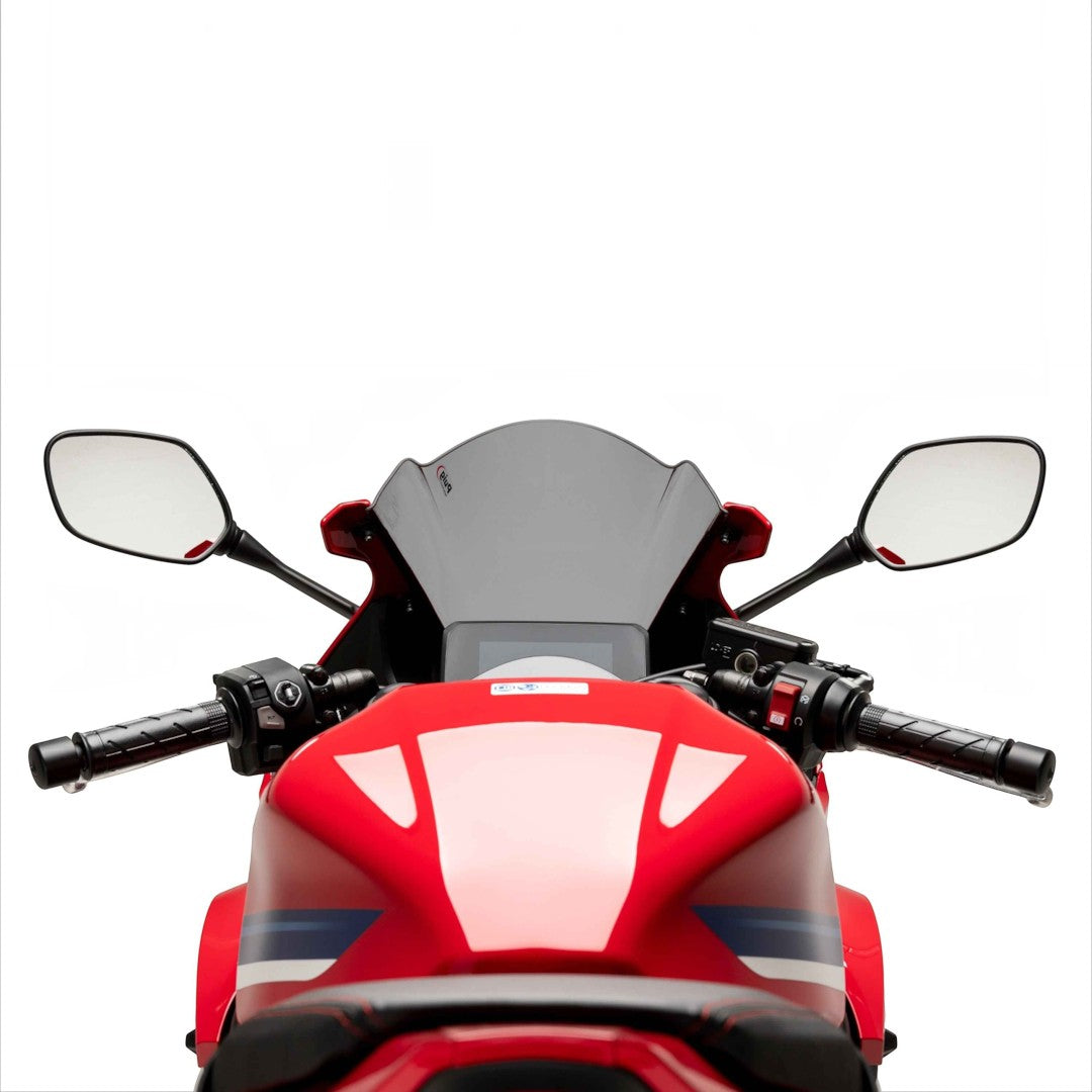 Motodrift Puig Z-Racing dark smoke windscreen installed on a red Honda CBR650R motorcycle, viewed from the rider seat.