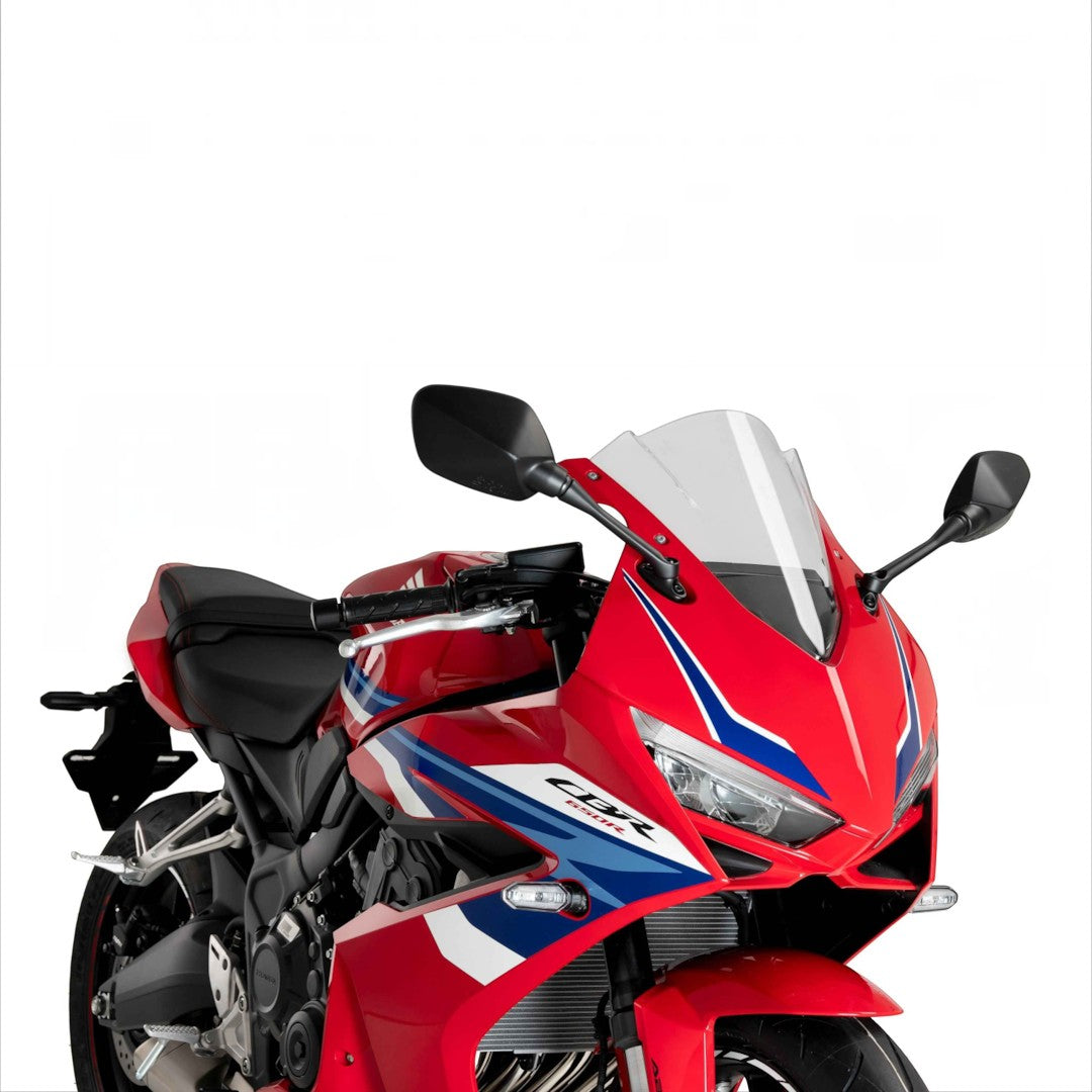Motodrift Puig Z-Racing clear windscreen installed on a red Honda CBR650R motorcycle for improved aerodynamics.