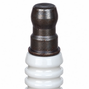 NGK Laser Iridium spark plug terminal nut detail showing the white ceramic insulator and metal top