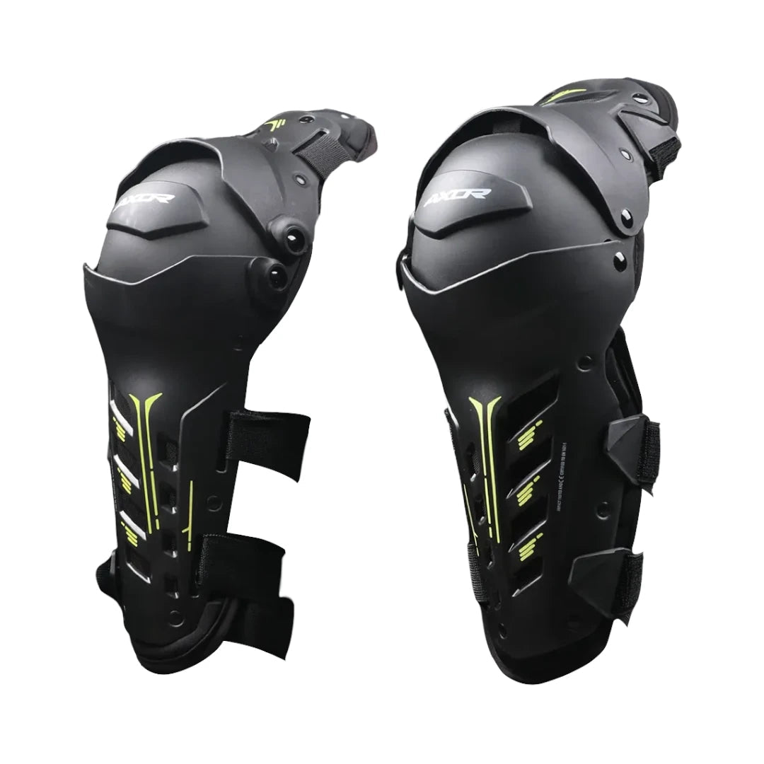 AXOR Impact-X black knee guards with yellow accents, dual-axis bionic design, and hard shell protection.