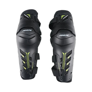 AXOR Impact-X black knee guards with neon yellow accents, dual-axis design, and hard shell protection.