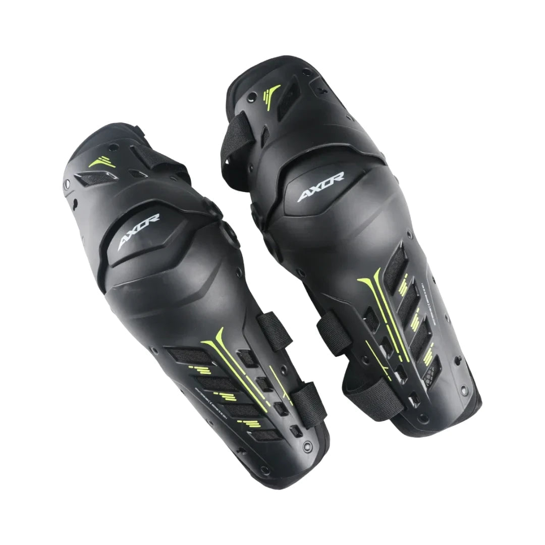AXOR Impact-X black knee guards with neon yellow accents, featuring hard shell sliders and dual-axis design.