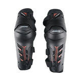 AXOR Impact-X black knee guards with dual-axis bionic design, hard shell sliders, and red accent details.