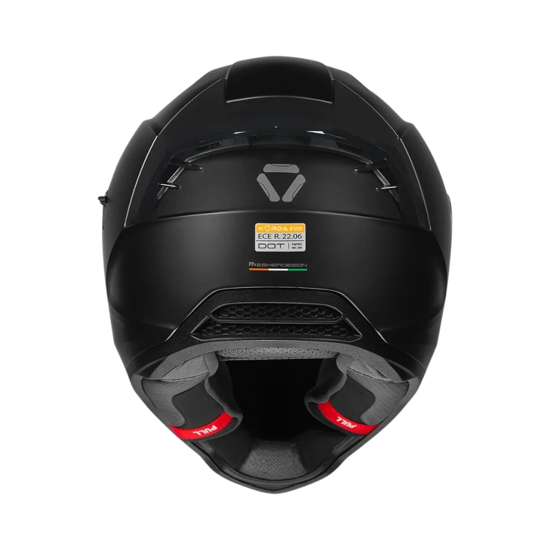 Motodrift Korda Evo Solid full face motorcycle helmet in matte black, rear view showing ventilation and safety labels.