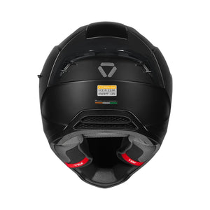 Motodrift Korda Evo Solid full face motorcycle helmet in matte black, rear view showing ventilation and safety labels.