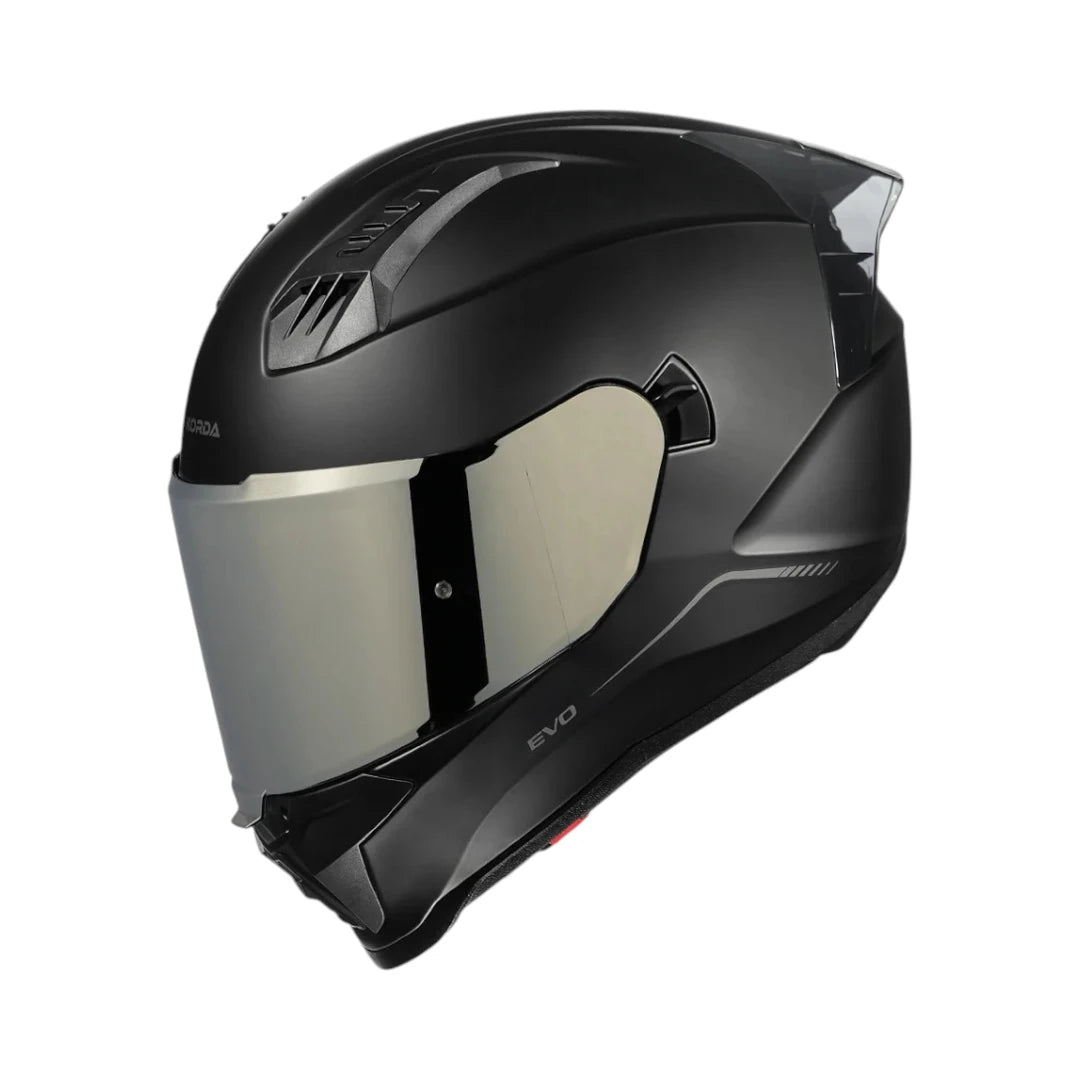 Motodrift Korda Evo Solid full-face motorcycle helmet in matte black with a clear visor and aerodynamic shell design.