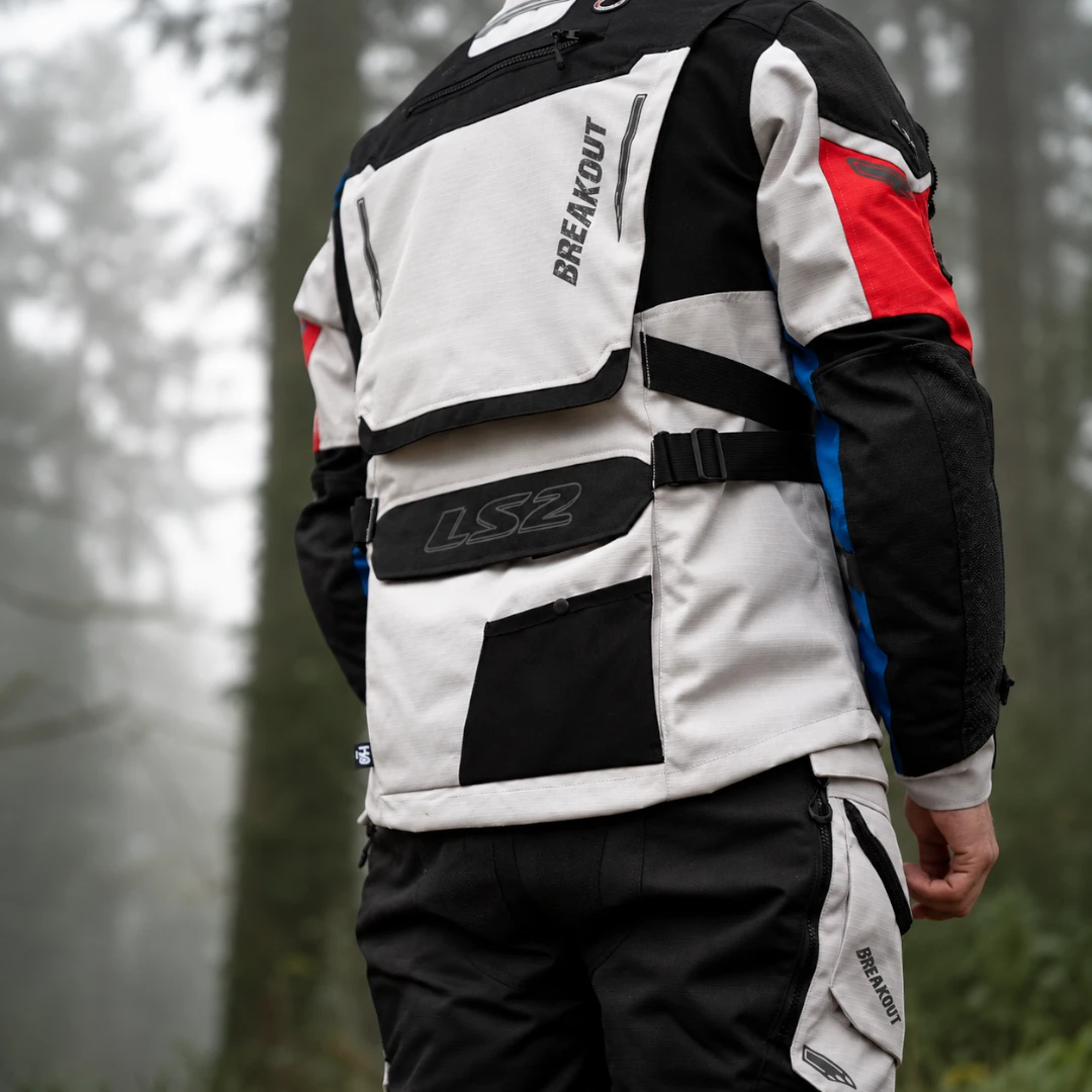 LS2 Breakout adventure touring motorcycle jacket in grey, black, and red, featuring back storage and straps.