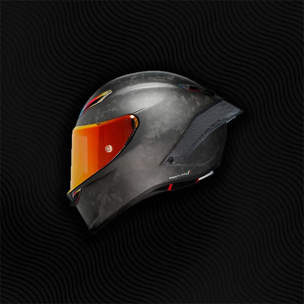 Black motorcycle helmet with orange visor on a black background