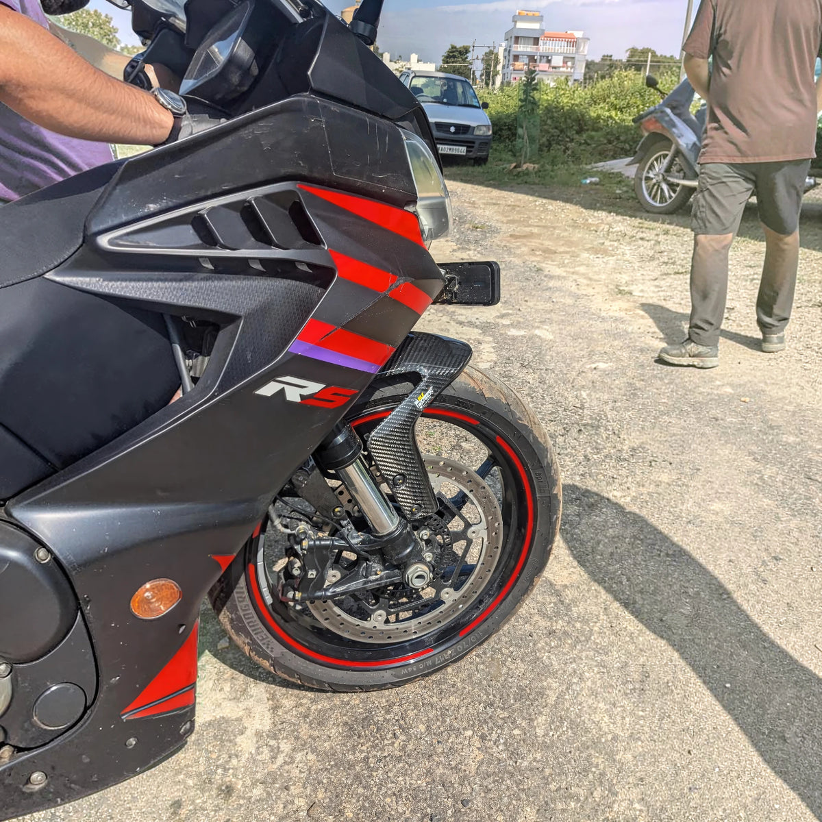 Three-quarter front view of Aprilia RS 457 with black and red bodywork
