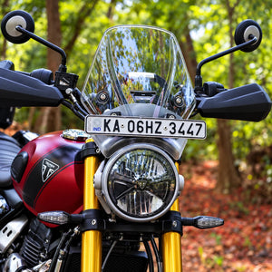 Clear BOLT windscreen installed on a red Triumph Scrambler 400X with GPS mount and number plate holder.