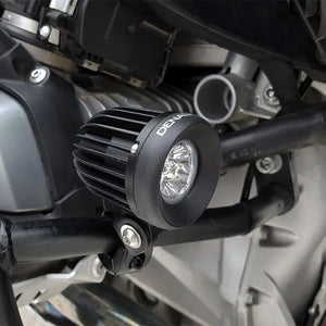 DENALI D2 v2.0 black aluminum LED auxiliary light mounted on a motorcycle crash bar.