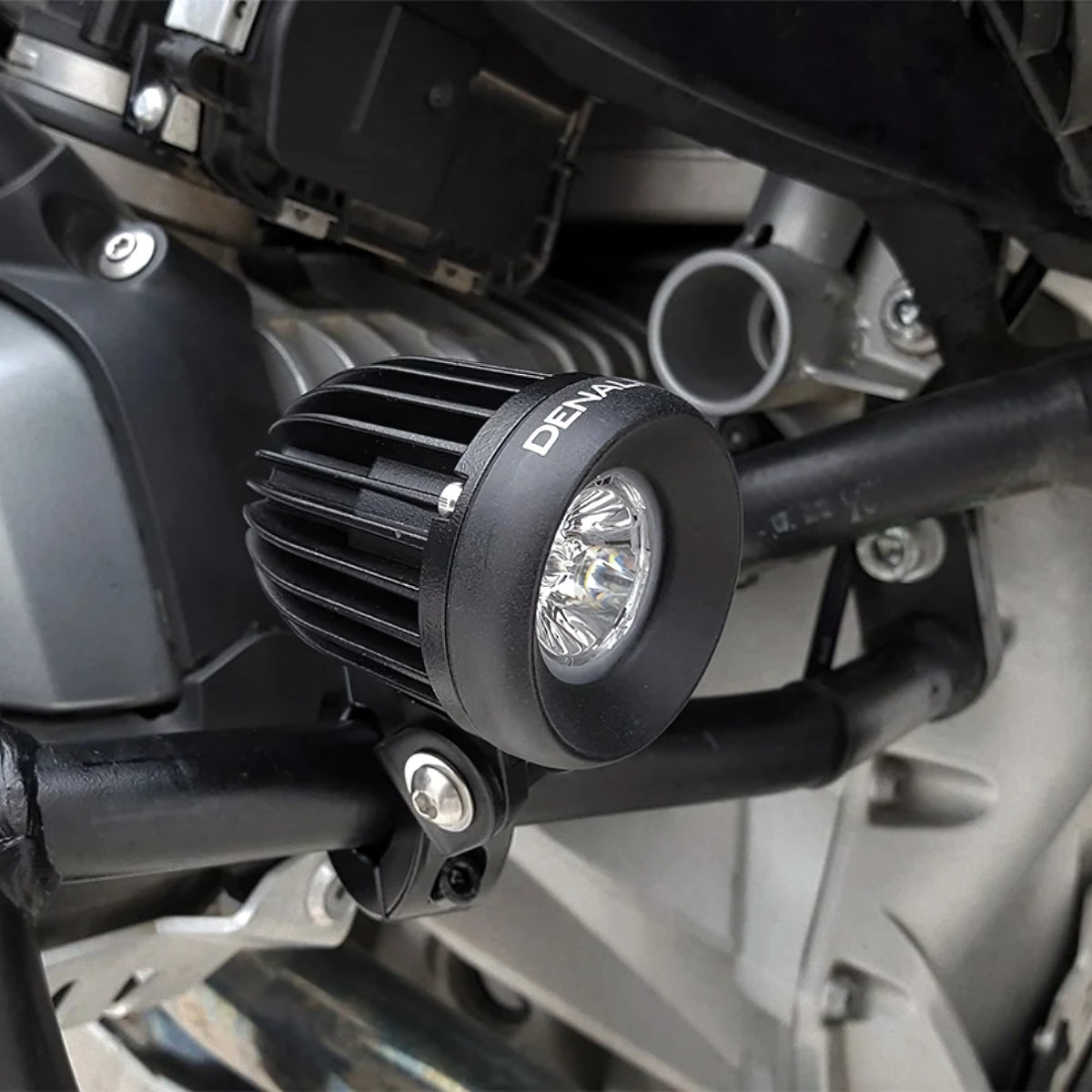 DENALI D2 v2.0 black aluminum LED auxiliary light mounted on a motorcycle crash bar.