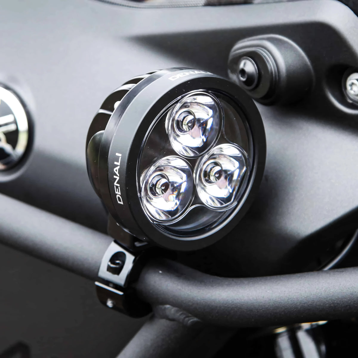 DENALI D3 LED motorcycle driving light with black housing and triple Cree LED spot beam lens.