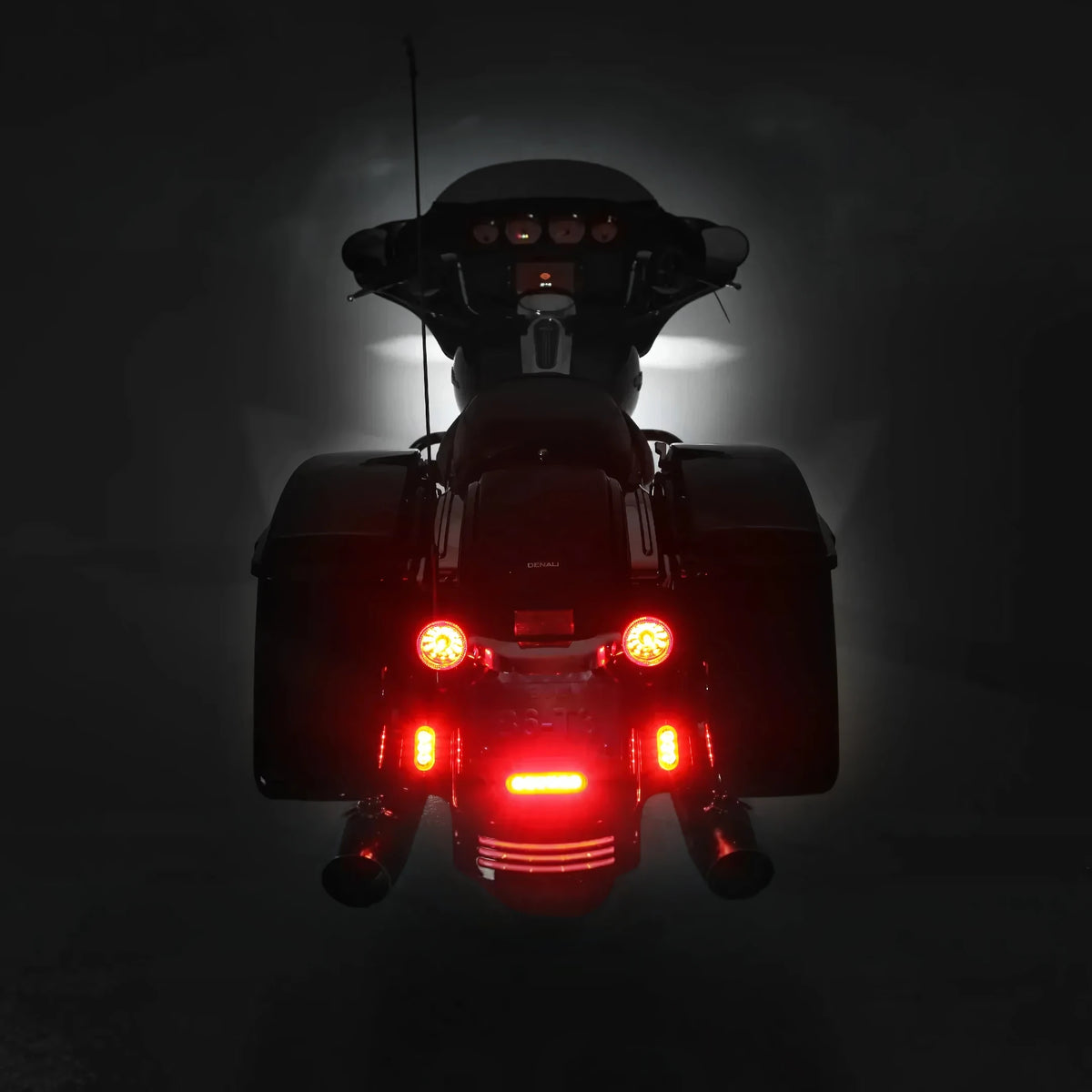DENALI T3 modular LED rear turn signal pods with red running and brake lights on a motorcycle