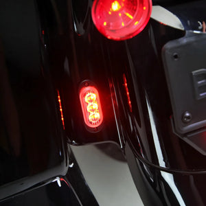 DENALI T3 modular LED rear signal pod mounted on a motorcycle fender, glowing red as a running light.