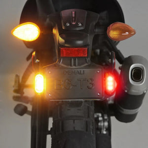 Denali T3 license plate mount with illuminated red and amber signal pods on a motorcycle rear