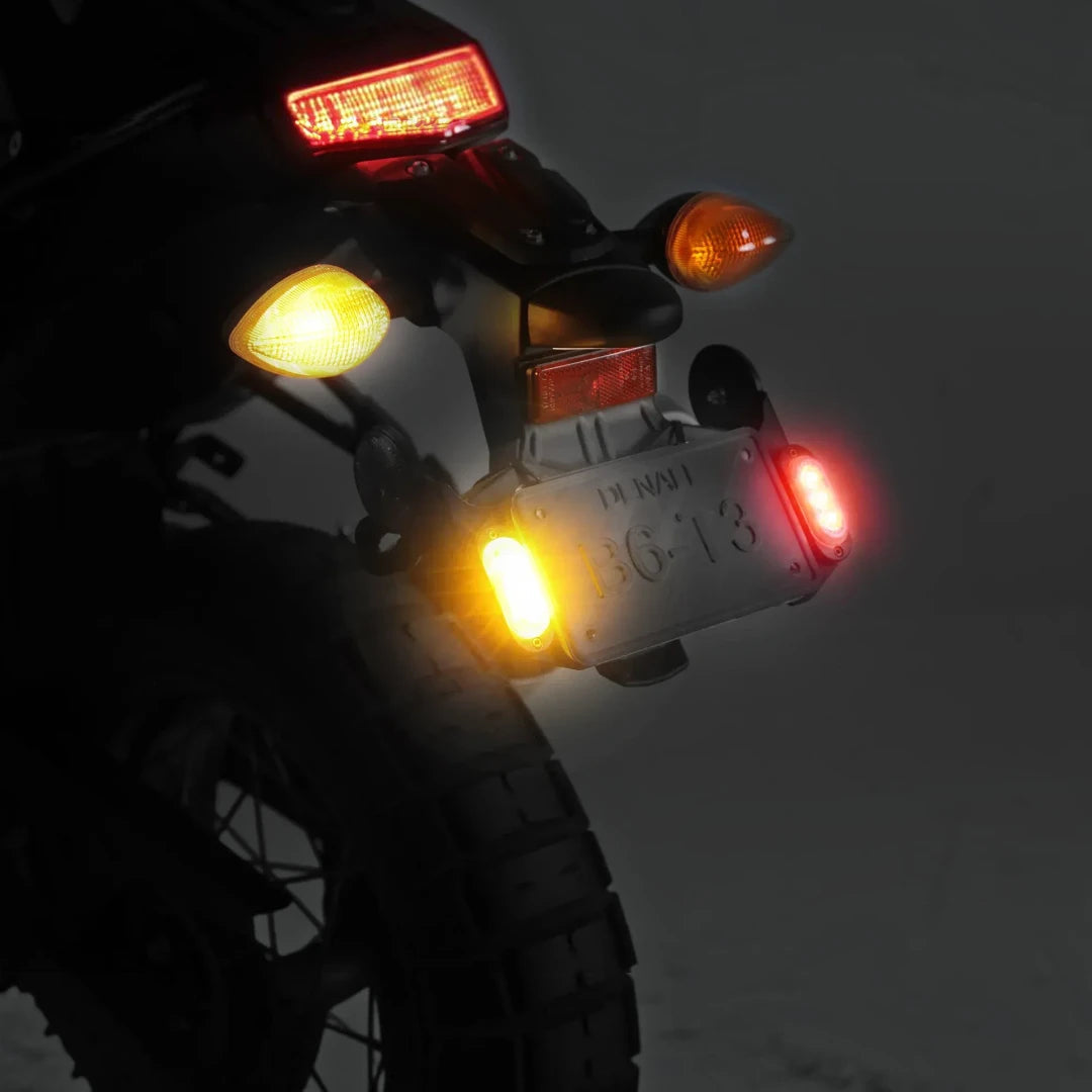 Denali T3 license plate mount with illuminated signal pods installed on a motorcycle rear fender