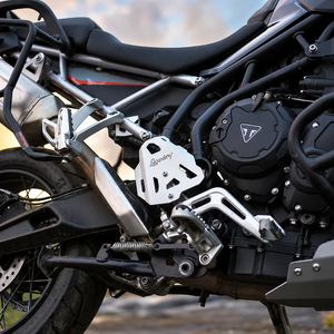 Silver aluminium Legundary Titan boot guards installed on a Triumph Tiger 900 motorcycle frame