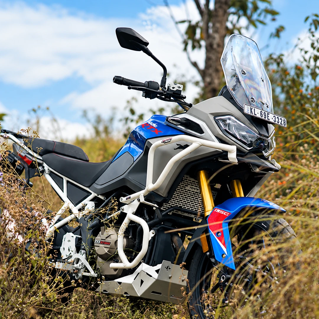 White Legundary Raptor crash guard set installed on a blue and grey TVS Apache RTX 300 adventure motorcycle