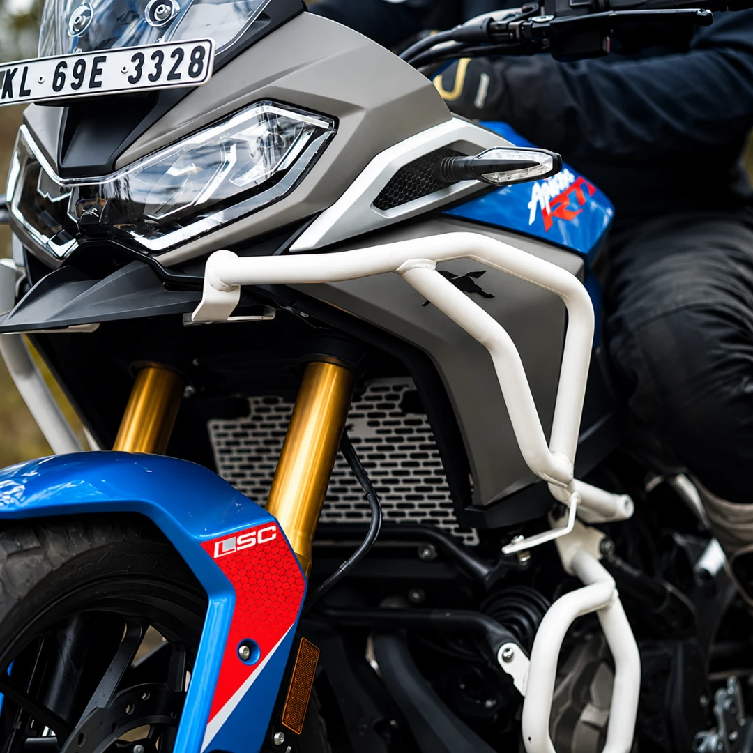 White Raptor crash guard set installed on a blue and grey TVS Apache RTX 300 motorcycle