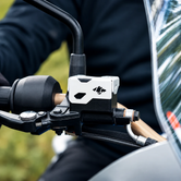 Silver CNC-machined aluminium Tricorn front oil cap installed on a TVS Apache RTX 300 motorcycle handlebar