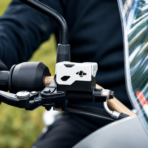 Silver CNC-machined aluminium Tricorn front oil cap installed on a TVS Apache RTX 300 motorcycle handlebar