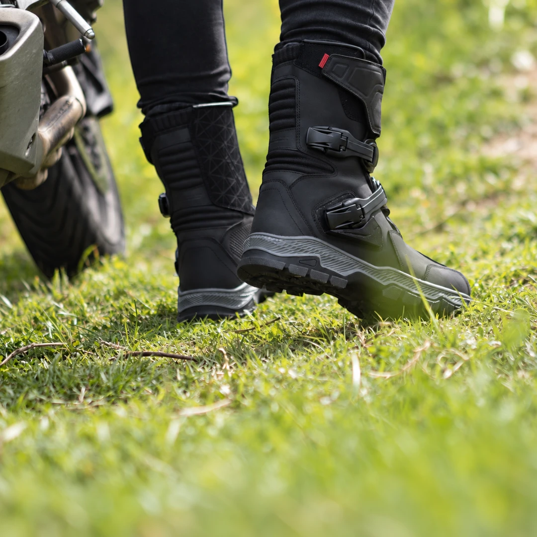 LS2 Adventure Boots in black buffalo leather with adjustable buckles, worn while standing on grass.