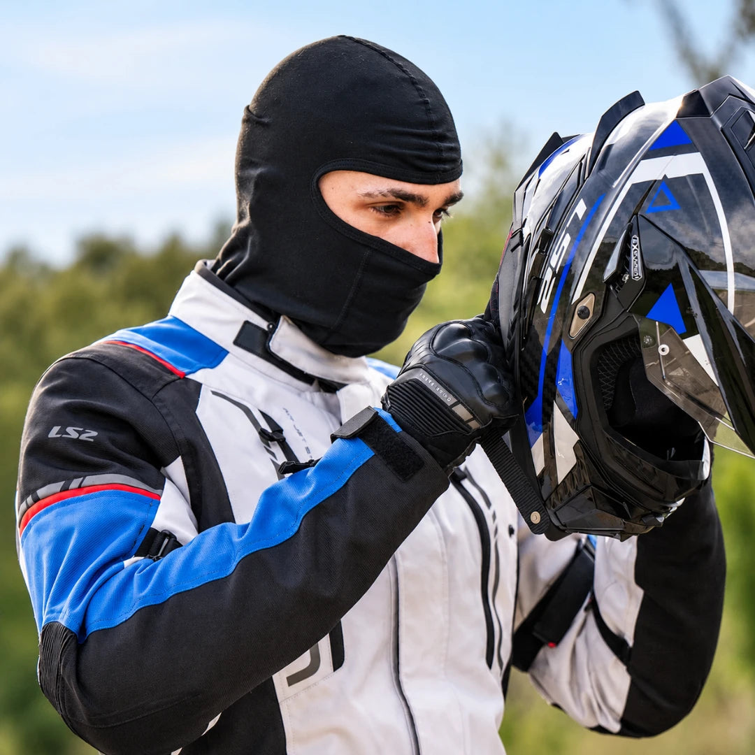 Rider wearing a black LS2 cotton balaclava under a motorcycle helmet for comfort and hygiene