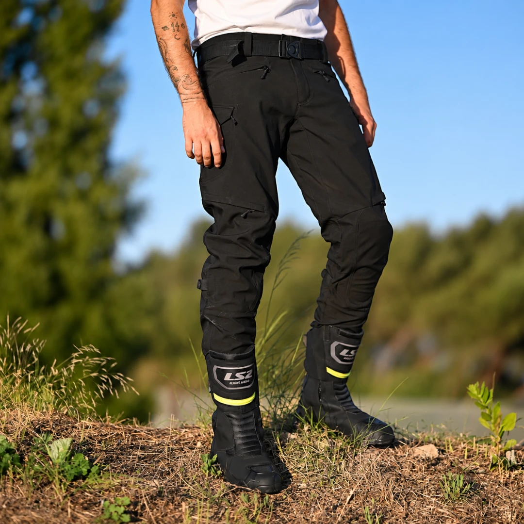 LS2 Goby waterproof touring motorcycle boots in black with reflective details worn by a rider outdoors