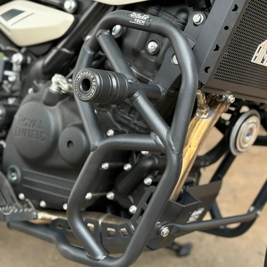 Black tubular steel crash guard with integrated slider for Royal Enfield Himalayan 450 engine protection.