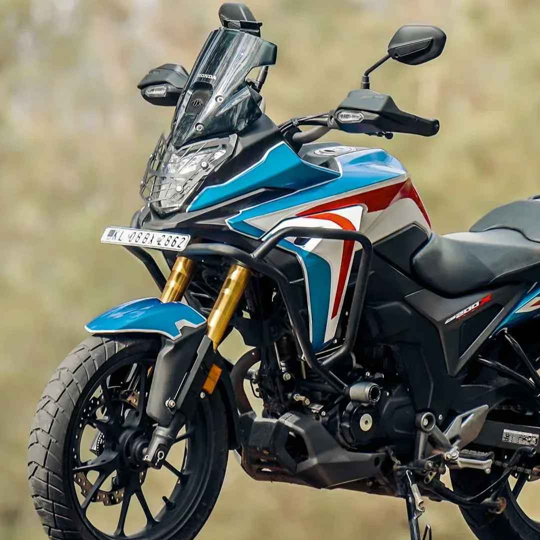 Motodrift Legundary Adrinex crash guard with slider installed on a blue and white Honda CB 200X motorcycle