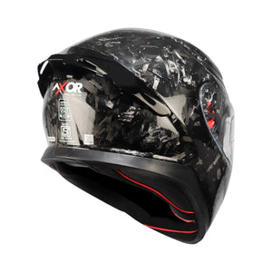 Motodrift Axor Apex forged carbon motorcycle helmet with integrated rear spoiler and safety certification labels.