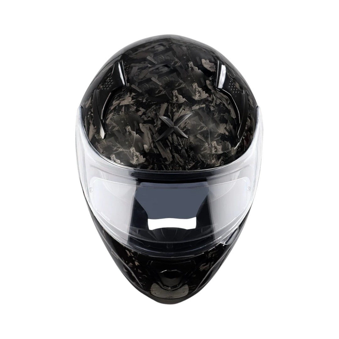 Motodrift Axor Apex forged carbon motorcycle helmet with a clear visor, front view showing the unique carbon fiber pattern.