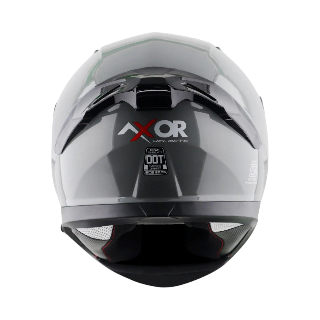 Motodrift Axor Apex solid grey full-face motorcycle helmet viewed from the back with DOT certification label