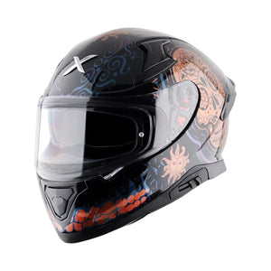 Motodrift Axor Apex Trance full-face helmet in black with intricate orange and blue sun and skull graphic designs.