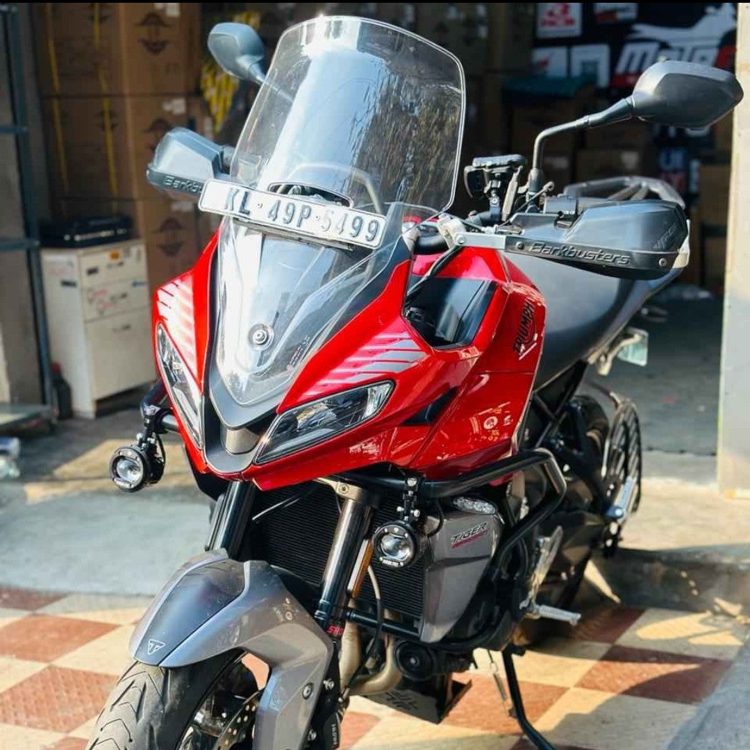 Motodrift Barkbusters VPS plastic handguards installed on a red Triumph Tiger adventure motorcycle