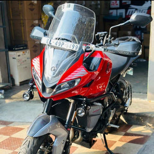 Motodrift Barkbusters VPS plastic handguards installed on a red Triumph Tiger adventure motorcycle
