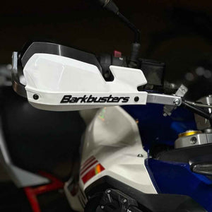 Motodrift Barkbusters VPS white plastic handguard shield mounted on a motorcycle handlebar for wind protection
